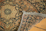 Antique Persian Jalili Tabriz rug corner with grey fabric banding, white stitching, and hand-knotted reverse.