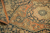 Finely woven antique Persian Jalili Tabriz rug showing intricate dusty rust and charcoal motifs.