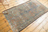 Vintage Belouch runner's tattered side cord selvage and threadbare rust and blue pattern.