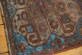 Southwest Persian rug detail: sapphire blue and brick red motifs with wear to foundation.