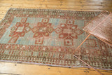 Running-T border and Laleh Abassi pawn motif on distressed powder blue rug.