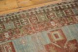 Patinaed pale blue and terra cotta with a Running-T border on this antique Caucasian rug.