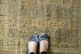 Textured surface of distressed Turkmen rug showing muted beige and faded blue elephant footprint guls.