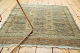 Distressed vintage Turkmen rug corner, dusty terra cotta rust geometric border, subtle abrash.