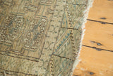 Distressed edge of a vintage Turkmen rug with subtle abrash and geometric motifs.