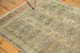 Distressed vintage Turkmen rug showing muted beige, faded blue Bokhara guls, and abrash.