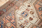 Distressed Malayer rug pile with even wear, light foundation, geometric vinery, blush, ivory, sky blue.