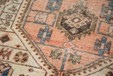 Distressed geometric vinery and floral cross sections in peach, ivory, and blue tones.