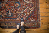 Antique Afshar rug end border with intricate serrated contouring, madder red and blue tones.