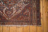 Antique Afshar rug corner with madder red, blue geometric border, worn pile, fringe.