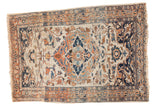 Antique Haji Jalili Tabriz rug with a navy and rust medallion and scrolling vinery on an ivory field.