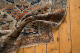 Worn corner of an antique Haji Jalili Tabriz showing the hand-knotted pile and tattered edge.