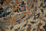 Detailed view of vak-vak motifs and scrolling vinery on an antique Haji Jalili rug.