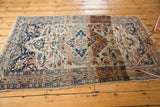 An antique Haji Jalili Tabriz rug displaying its complex pattern and notable color variation across the field.