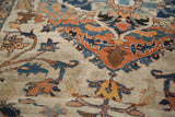 Close view of vak-vak style arabesques in rust and blue on an antique hand-knotted Persian rug.