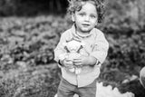 Adorable young child holding the soft organic cotton stuffed lion toy.