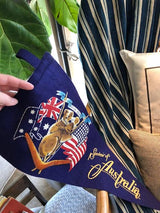 Yellow 'Souvenir of Australia' script, US flag, and boomerang on felt banner.