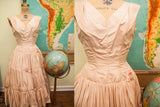 Vintage 50s blush pink taffeta dress with ruched bodice, tiered skirt, and hot pink rosebuds.
