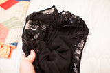 Close-up of vintage black lace, sequins, and gown's inner lining.