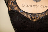 Intricate black lace pattern and shimmering sequins on the vintage evening gown.