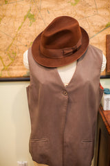 Vintage Burberry's brown suede vest with single button closure, small pockets, and fedora.