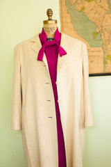 Ivory cashmere coat, open front detail with three buttons and magenta textile.