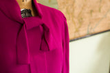 Vintage fuchsia dress with elegant tied neckline and gathered shoulder.