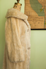 Ivory 60s sheared beaver fur coat with soft pile texture and round clear buttons.