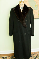 Black Dunhill Tailors wool coat showing lower buttons and pocket.