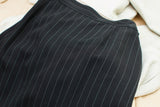 Vintage Gaultier suit skirt's black pinstripe fabric texture and tailored waist.