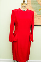 Side view of the red 80s Carolina Herrera dress, showing satin waist trim and ruffled peplum.