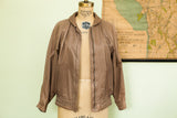Vintage Lillie Rubin 80s brown leather bubble jacket with a soft, supple texture.