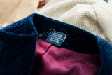 Blue velvet collar with subtle white polka dots, Geoffrey Beene label, and bright magenta lining.