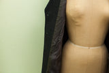Giorgio Armani suit jacket, open to reveal dark herringbone texture and satiny lining.