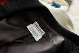 Giorgio Armani and Bergdorf Goodman labels on herringbone suit jacket's dark lining.