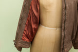 Lillie Rubin leather jacket sleeve showing reddish-orange lining and brown zipper.
