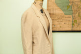 Side profile of a vintage Abercrombie jacket in tan cashmere, showing the lapel and shoulder.