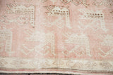 Peach rose field and light beige geometric patterns on a vintage Turkish Oushak carpet.