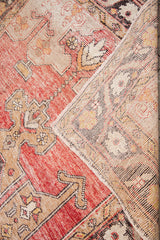 Distressed red and saffron vintage Oushak rug pile with view of its hand-knotted reverse.