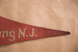 Off-white gothic 'ng N.J.' lettering detail on vintage red felt Bertrand Island pennant.
