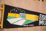 Angled detail of the yellow, green, and white Eisenhower Museum graphic on black felt.