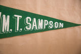 Close-up of the white block lettering on the vintage green felt pennant.