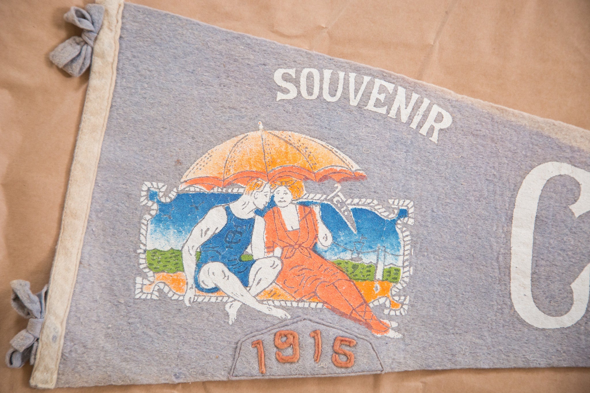 Graphic of beach goers on antique 1915 coney island NY felt flag pennant