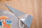 Pointed end of the antique Coney Island felt pennant, secured with tape.