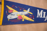 Vintage Miami Beach felt flag with white propeller airplane graphic and MI lettering.