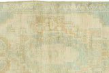 Muted abstract Oushak pattern in blanched ivory, seafoam, and gold, with subtle border.