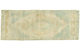 Vintage Oushak rug featuring blanched ivory, seafoam green, gold, and beige stylized design, 2'7
