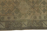 Lower right corner of vintage Oushak rug with charcoal geometric patterns and minor discoloration.