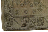 Oushak rug corner: charcoal geometric patterns, star motifs on antique ivory. Minor discoloration present.