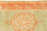 Brilliant rusty orange Oushak border and medallion on light green field.